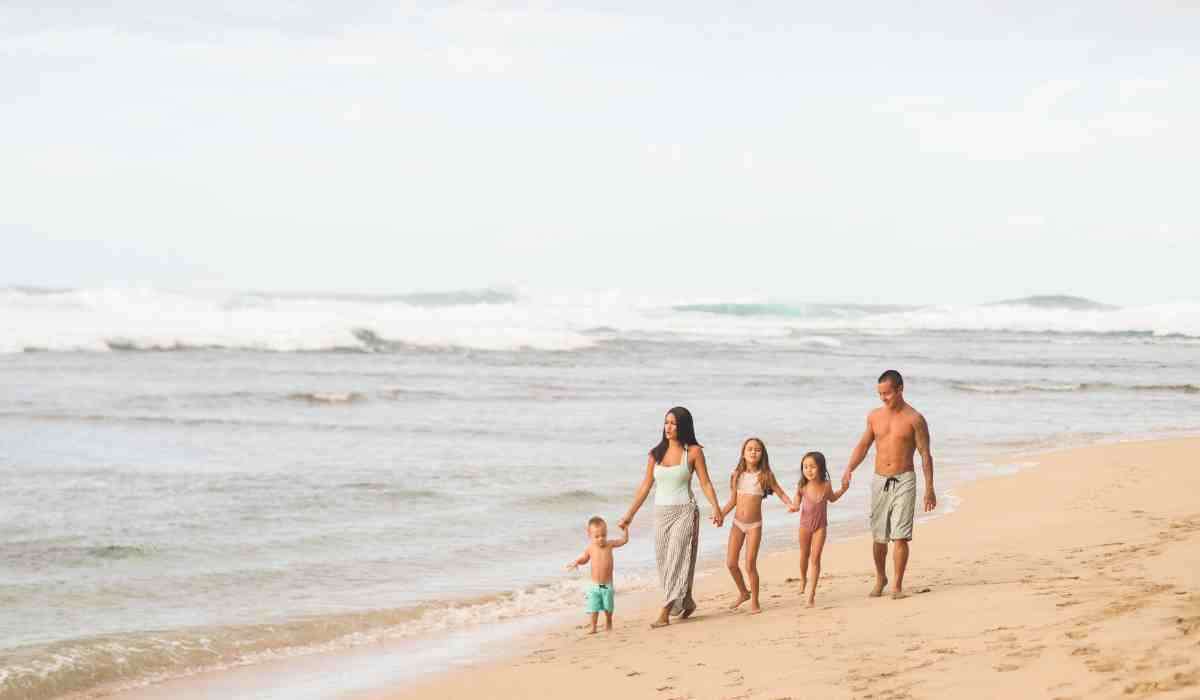 Happy family on vacation exploring a beach